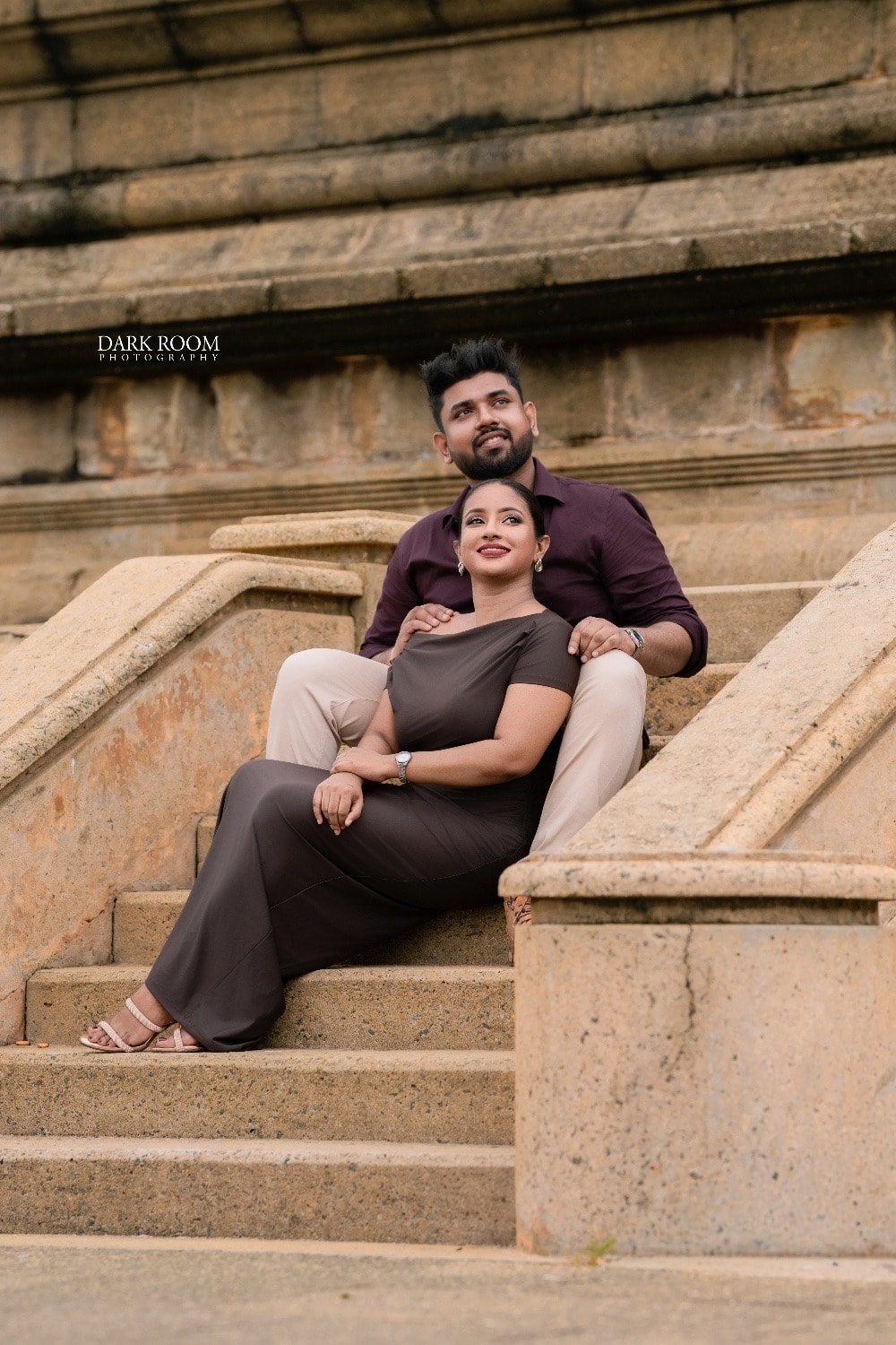 Ashan and Oshini sitting together on old stone steps